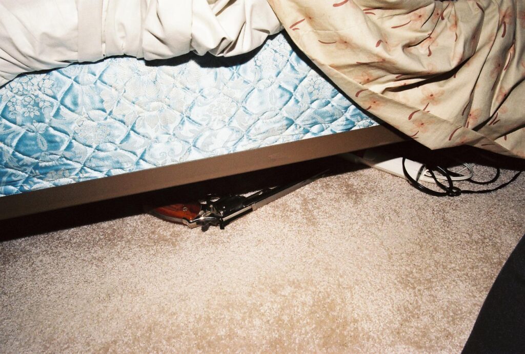 Gun underneath a bed