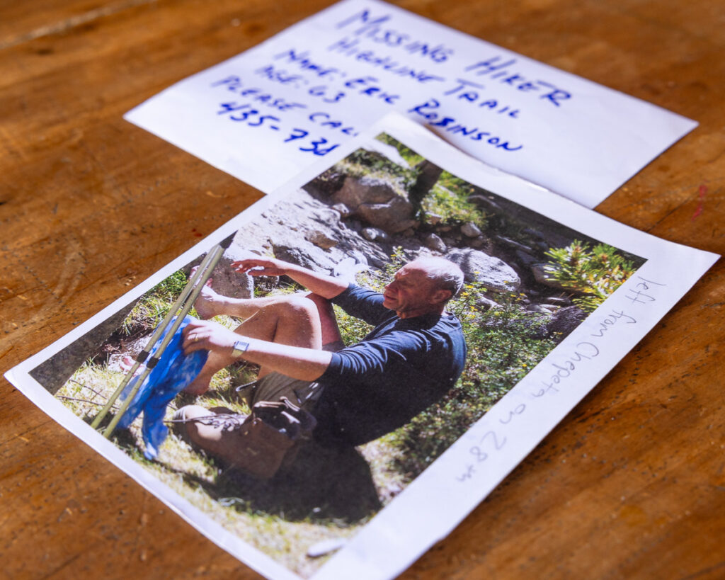 A missing persons flier for Australian Eric Robinson sits on a wood table