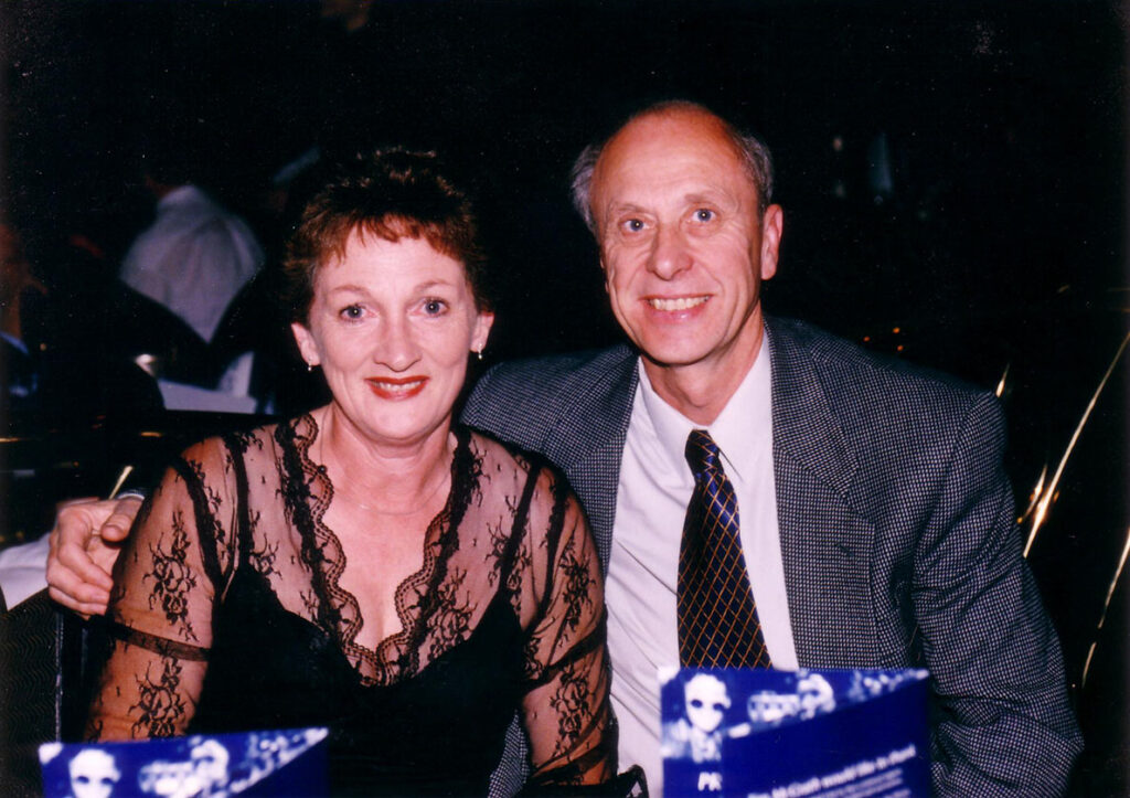 Marilyn Koolstra and Eric Robinson pose for a photo while seated together