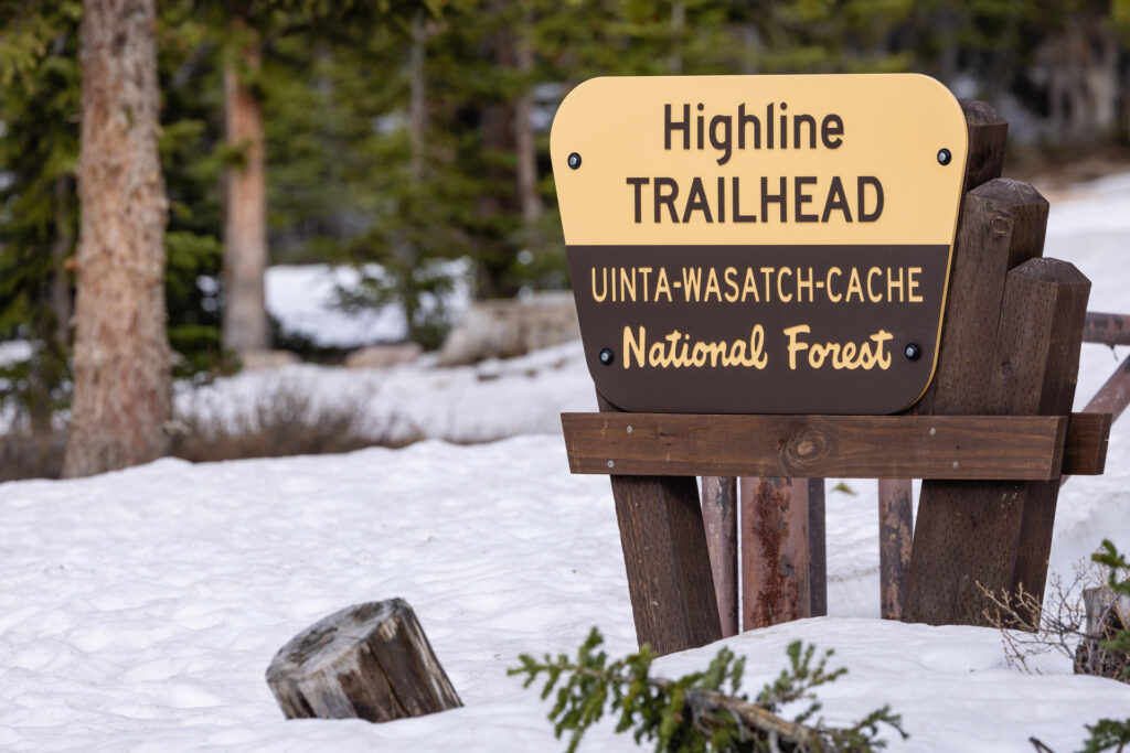 Snow surrounds a sign for the Highline Trialhead in the Uinta Mountains