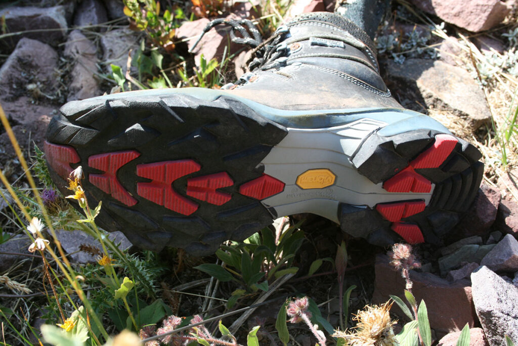 A worn leather hiking boot with a Vibram sole