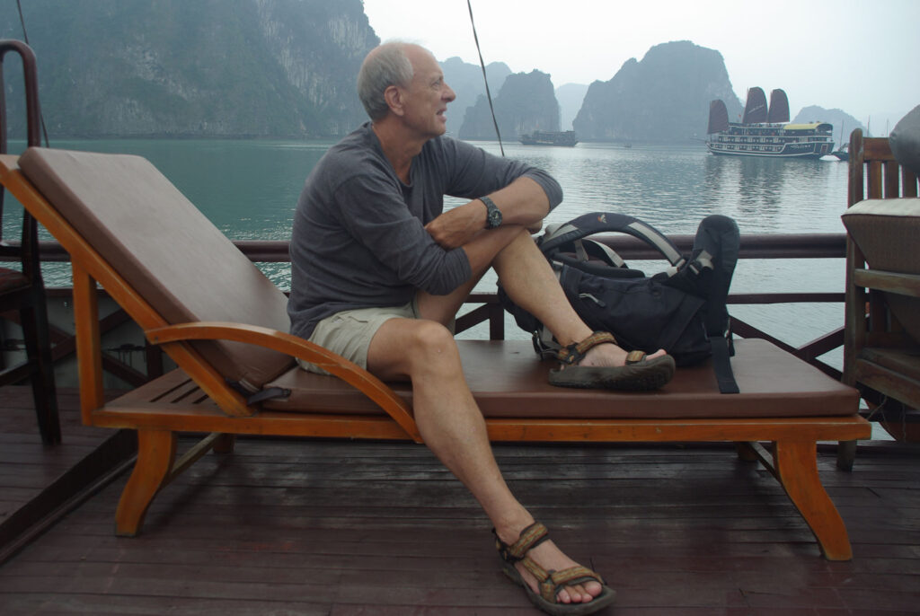 Australian trekker Eric Robinson sits on a lounge chair aboard a boat in Halong Bay, Vietnam