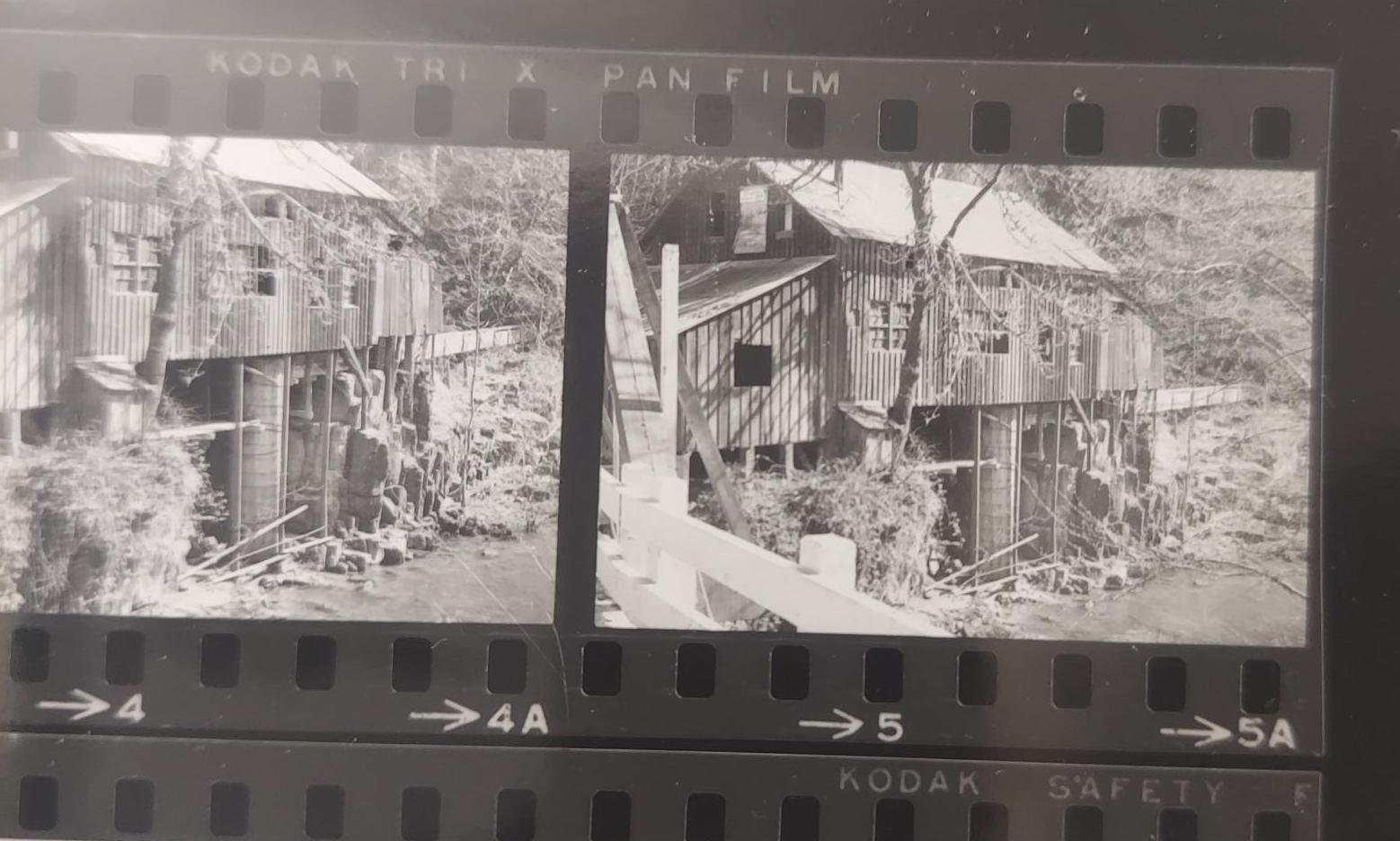 Black and white image of a crumbling mill in the moods.