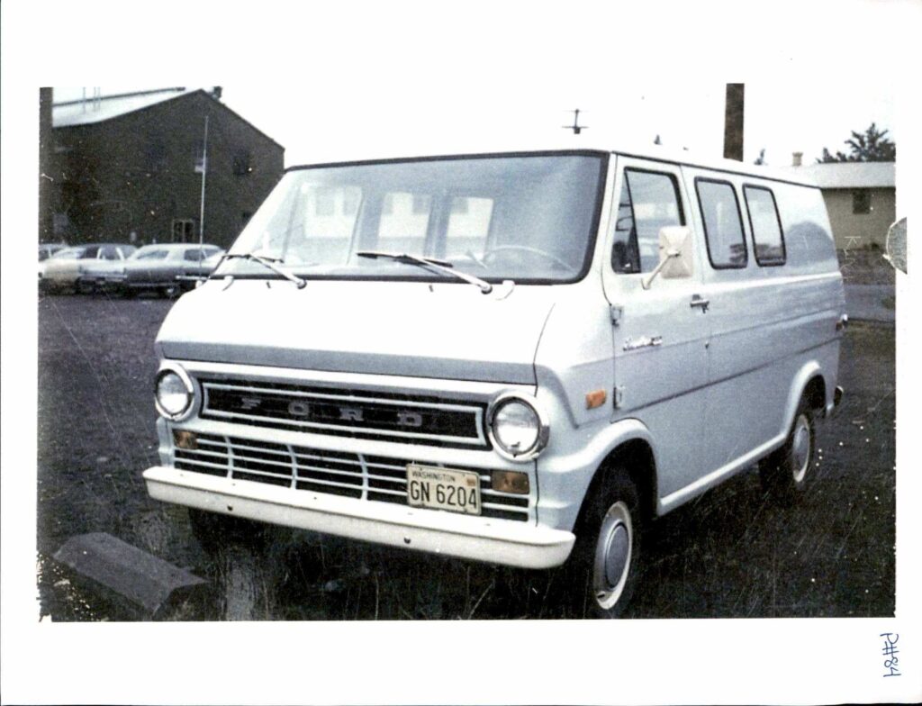 A light blue Ford van.